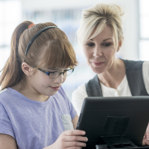 Girl using a tablet with support staff